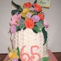 Basketful Of Flowers Buttercream basketweave on 4 8 inch rounds stacked. Gumpaste/fondant daffodils, roses, hydrangeas and mums. Done for my aunt's 65th...