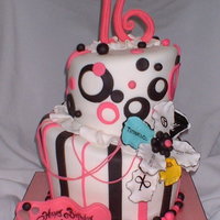 Lucy's Cake 2 tier topsy turvy. Gumpaste fantasy flower with various logos for the fashionista, modeling chocolate numbers and banner.