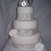 A Little Bling 3 tier (6, 9, 12) fondant covered with gumpaste rose and faux rhinestone banding.