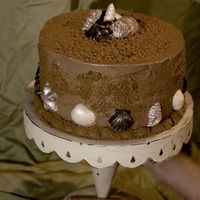 Mom's Birthday Cake I made this cake for mother. It is a chocolate cake with a peanut butter cookie filling and chocolate SMBC. The sand is crushed nutter...