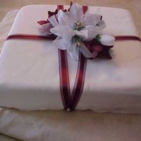 One Month Anniversary Cake White And Burgundy Lilies White Cake with Raspberry filling to mimic the wedding cake. Fondant in vanilla and a burgundy sheer ribbon adorn the cake. I had not...