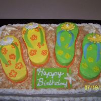 Flip Flops/beach I wanted to try to do a flip flop cake, but needed to feed 50 people so I did this one 1/2 Sheet BC with fondant straps and Royal flowers...