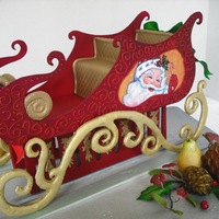 "the Red Sleigh" The sleigh,fruits,pinecones,etc. were completely out of gumpaste for a jewelry store window display.The painting of SANTA was done with...
