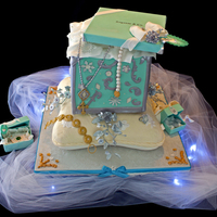 Tiffany Cake Tiffany box cake on a pillow cake for a 21 year old girl's birthday.all other small Tiffany boxes and jewelry are made from gumpaste...