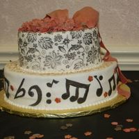 Musical Birthda;y Music notes, gold and black accents, gumpaste roses and bows with ribbon.