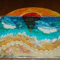 Beach, Shells, Dolphins, Sunset Beachy sunset scene with fondant shells, fondant dolphins and painted sunset with food colors. Crushed van. wafers for sand and toasted...