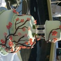 Japanese Cherry Blossoms With Pandas Gumpaste flowers and leaves, chocolate fondant for stems.