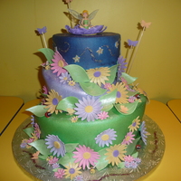 Tinkerbell 12" and 9" cake. The top teir was a 6" styrofoam piece. I inserted LED lights and the stars lit up. Stars were covered in...