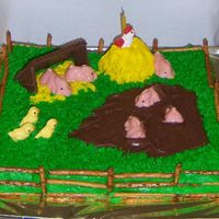 Pigs This cake was made for a co-workers Birthday. She is a Pig collector.It is made with buttercreme frosting and animal shaped candy molds.