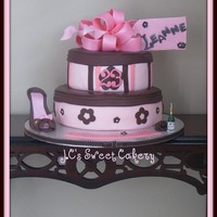 Pinky Made for someone celebrating her champagne birthday. gumpaste bow,tag,shoe. Candle champagne bottle.