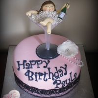 Bubbles 9" chocolate w/cookies & cream filling. Gumpaste flower & girl in edible pearls. Real lace around cake & champagne candle...