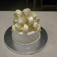 Birthday Cake 6" cake. Vanilla and Almond pound cake, butter cream frosting, and a fondant bow.