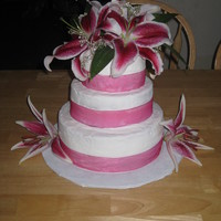 Simple Pink all buttercream, pink ribbon, and real stargazer lilies