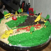 Tonka Road Construction Birthday Cake I used a horeshoe pan, buttercream icing , pretzel sticks for treesoreo crushed for the dirt,