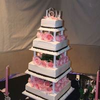 A_Stevens_Briana.jpg This cake was done for my boss' daughter's wedding. She wanted a simple design squares with white buttercream and black ribbon....