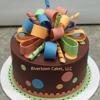 Present Birthday Cake 8" Marble cake with chocolate buttercream and fondant accents.