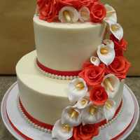060610 Wedding frosted in buttercream with red satin ribbon border and fake pearls, handmade gumpaste calla lilies and roses