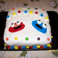 Elmo & Cookie Monster yellow cake, buttercream filler and icing. MMF homemade fondant. My 1st ever decorated cake.
