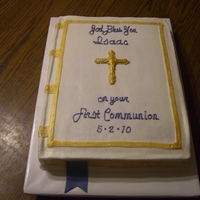 First Communion White cake with buttercream icing. The cross and bookmark are made of fondant.