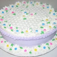 Daisy Cake Fondant flowers,everything else is buttercream. I had to put the silly star border around the top edge to support my rope border that was...