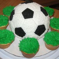 Soccerball Cake With Grass Cupcakes I made this cake for my friends son on his birthday. He requested it after he saw the basketball cake I made. This design was a little...