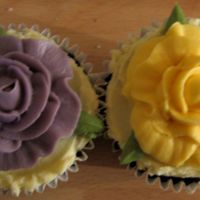 Wedding Cupcakes Chocolate and guiness cupcakes with a yellow and purple buttercream rose and leaves.
