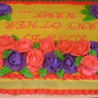 Cake_2_Small.jpg A lemon cake with buttercream icing. (Just practicing my roses....)