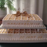 Wedding Reception Sheet Cakes 9x13 and 12x18 inch sheet cakes with gold lustre spray on the tops. . Topper of silver jewelry wire and Swarovski crystals.