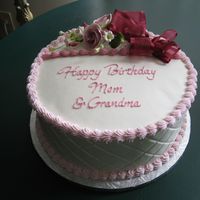 Birthday Cake For Mom's Birthday 10 inch round layers with diamond imprint on side. Purchased flowers from GSA with bow I made. Done in buttercream.