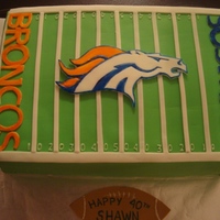 Denver Broncos Chocolate cake filled with vanilla buttercream. All letters and mascot were cut from fondant and painted with food colouring.