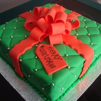 Christmas Present Cake All covered in fondant with fondant bow. The silver dragees are edible as well.