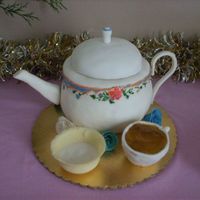Teapot Teapot, handpainted. Sugar bowl is made of white chocolate, tea cup w/tea is made of small wonder-mold pan and piping gel.