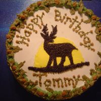 Deer Cake I used buttercream icing. I made a wreath border to give it a woodsie look. Around the side I piped in camoflauge using tip 16.
