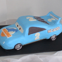 The King! The King, from the movie Cars. I made this for my son's second birthday, and he was thrilled! The cake is free-hand carved and iced in...