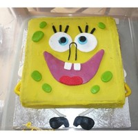 Sponge Bob Cake Banana cake covered in white chocolate ganache coloured yellow, decoration all in fondant. the colours mixed a bit, was a bit disappointed...