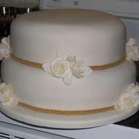 122325747938736.jpg 50th wedding anniversary cake. Carrot cake with ivory fondant, roses and leaves are half fondant and half gumpaste, it was so HEAVY! I'...