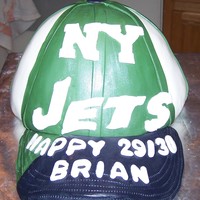 New York Jets Baseball Cap This is a Jets baseball cap. It's a yellow cake with BC frosting covered in fondant.