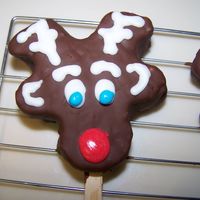 Reindeer Treats Inspired by all the cookies on here. these are chocolate covered rice krispie treats with royal icing for my son's christmas party at...