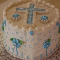 Easter Cross Cake B/C icing with Royal Icing flowers, cross, and rosettes.