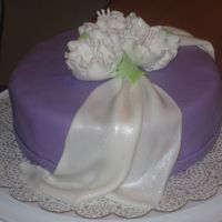 White Drape And Roses made this for my final wilton gumpaste/fondant class. fun! butter cake with buttercream filling. MMF drape, covering and gumpaste flowers....