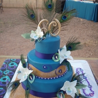 Sylvia's 60Th Birthday Cake This was for my MIL's 60th surprise party. Fondant and gumpaste flowers in peacock feather colors. My first time making orchids. I...