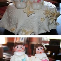 Little Angels,1St Communion This cake is for my friend's twins.The angels are knelt .White cake with butterscoth and white chocolate filling, MMF for the cover...
