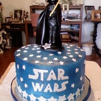 Darth Vader/star Wars Cake Darth is made of gumpaste, so the young man can keep him and the cake was buttercream airbrushed with blue and fondant stars