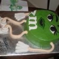 Green Mm I used a 10" cake and covered it in BC. The arms,legs, eyes, eye brows, and the "m" are made of fondant.. On the side I put...