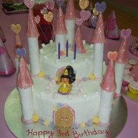 My Daughters 3Rd Birthday Fondant icing, marshmellows for edges and trimmed icecream cones dipped in coloured melted white chocolate for tower toppers.