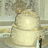 First Fondant Wedding Cake - French vanilla with strawberry filling and Buttercream. MMF, gumpaste roses and calla lillies - there is a glass bead "C" and...