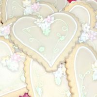 Wedding Favor Cookies - Hearts NFSC with royal, glaze, and MMF flowers. This pic is prior to them being bagged and tied with a silver bow and a tag with the couple info...