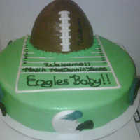 Baby Shower Football Cake Bottom-yellow cake 16inch iced in Rum flavored Buttercream, Football chocolate iced in Rum Flavored Buttercream w/fondant accents. Helmets...