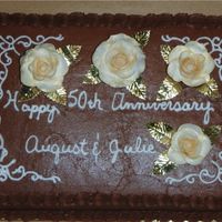 Anniversary Cake Chocolate cake with Chocolate frosting. Gumpaste roses for 50th anniversary. Icing turned out a little dry, but I think it turned out okay...