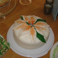 Poinsettia Cake Fluffy white cake with a mandarin.clementine orange filling, butter cream frosting and fondant.